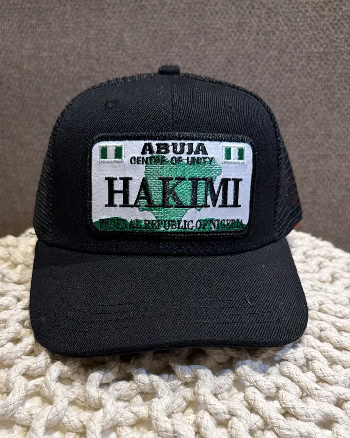 Black Point A cap with an Abuja plate reading HAKIMI